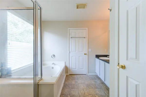 a bathroom with a glass shower door