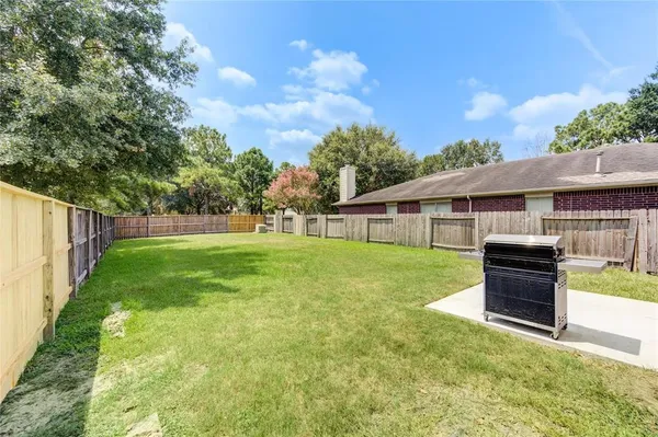 a view of house with backyard space and garden