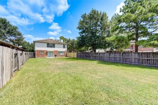 a view of a house with pool and a yard