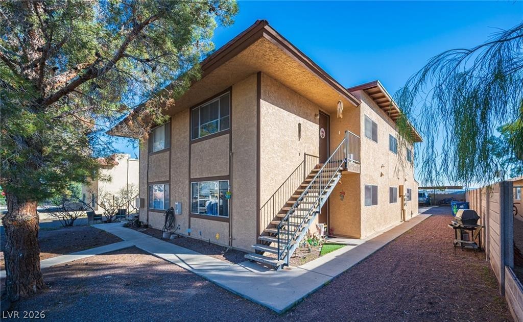 855 Del Rey Drive Boulder City, NV 89005 - Photo 2 of 12 A classic two-story stucco building with external stairs offers multiple living units.