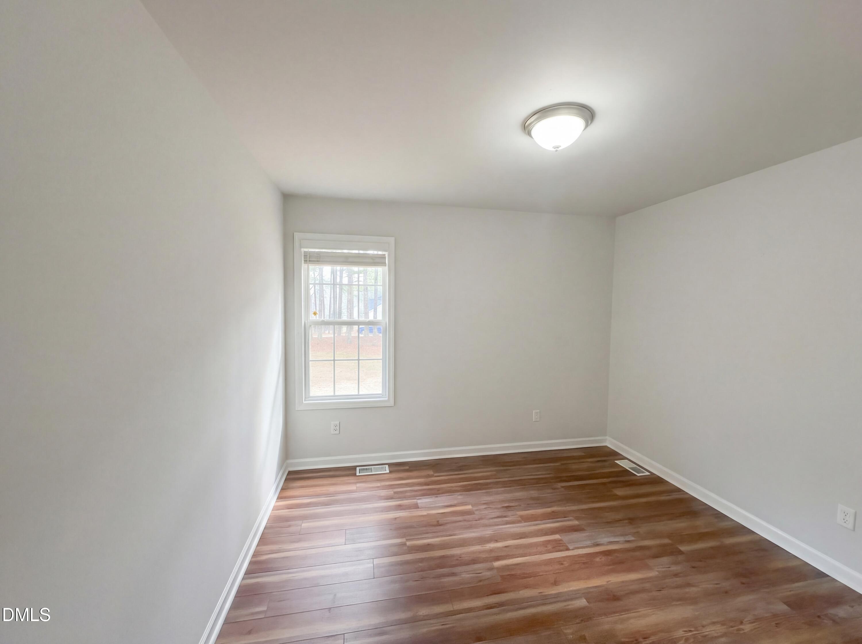 299 Greenleaf Road Angier, NC 27501 - Photo 13 of 15 wooden floor in an empty room with a window