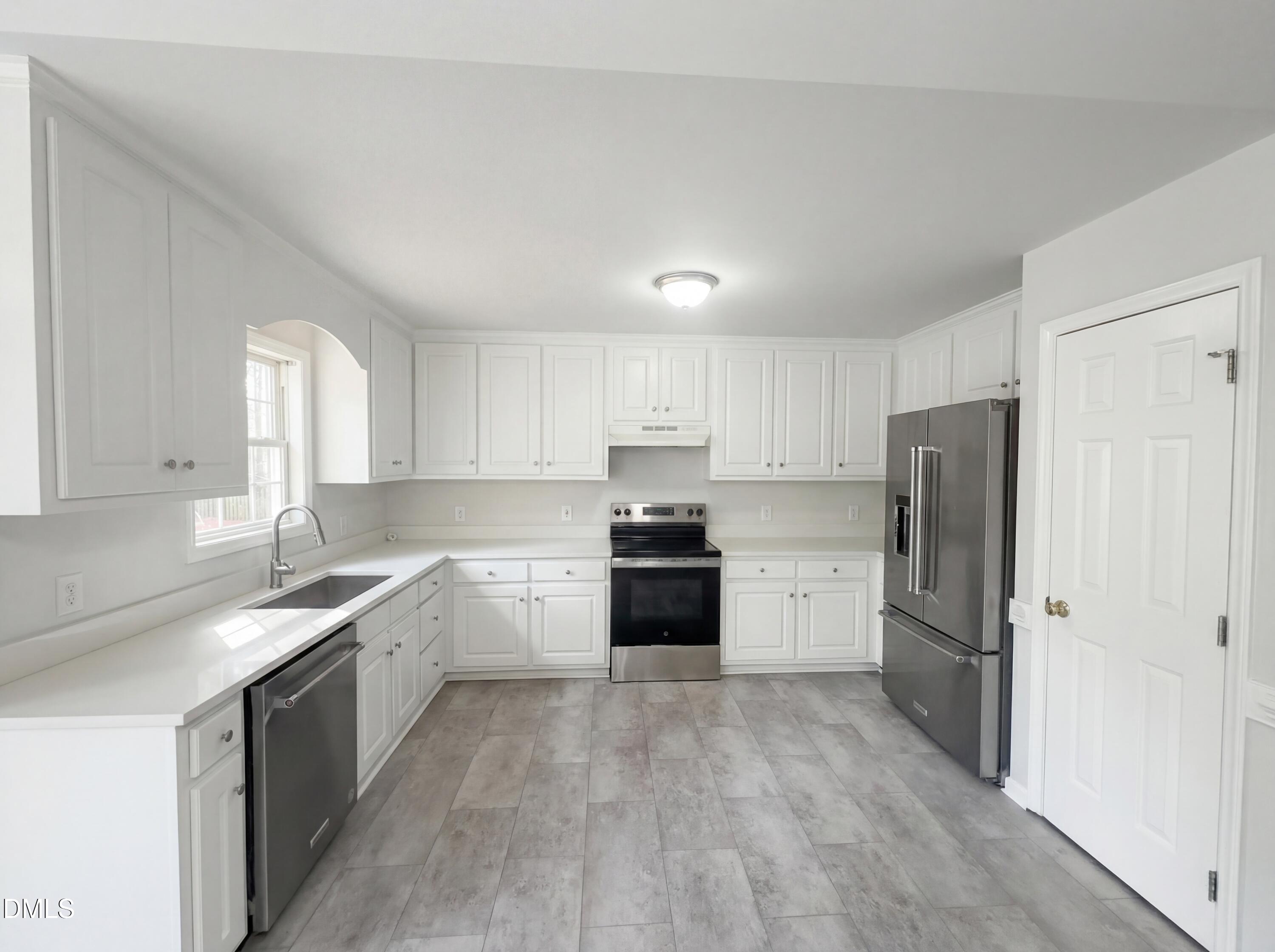 299 Greenleaf Road Angier, NC 27501 - Photo 2 of 15 a kitchen with a refrigerator a sink and dishwasher with wooden cabinets