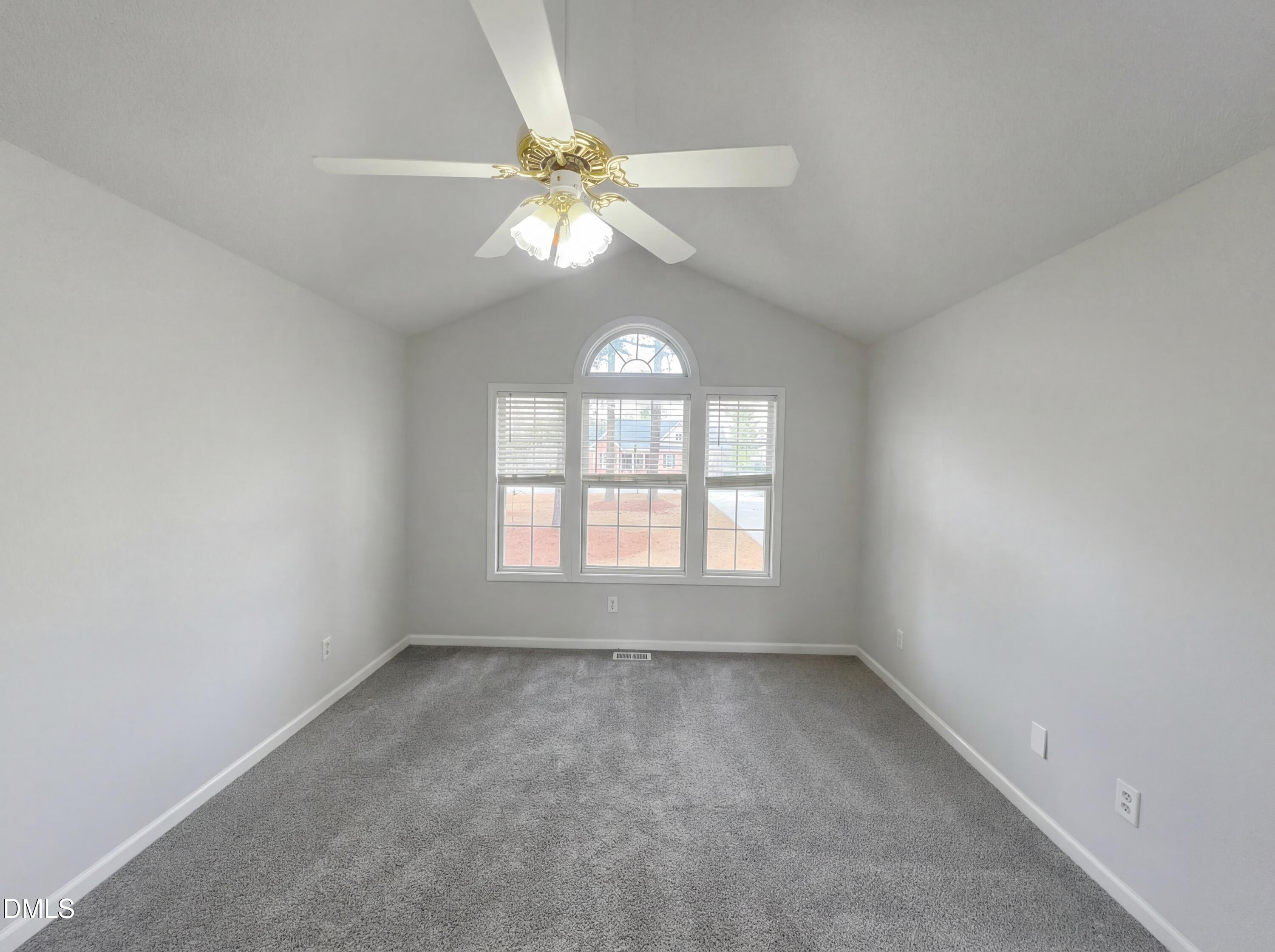 299 Greenleaf Road Angier, NC 27501 - Photo 7 of 15 an empty room with a window and a fan