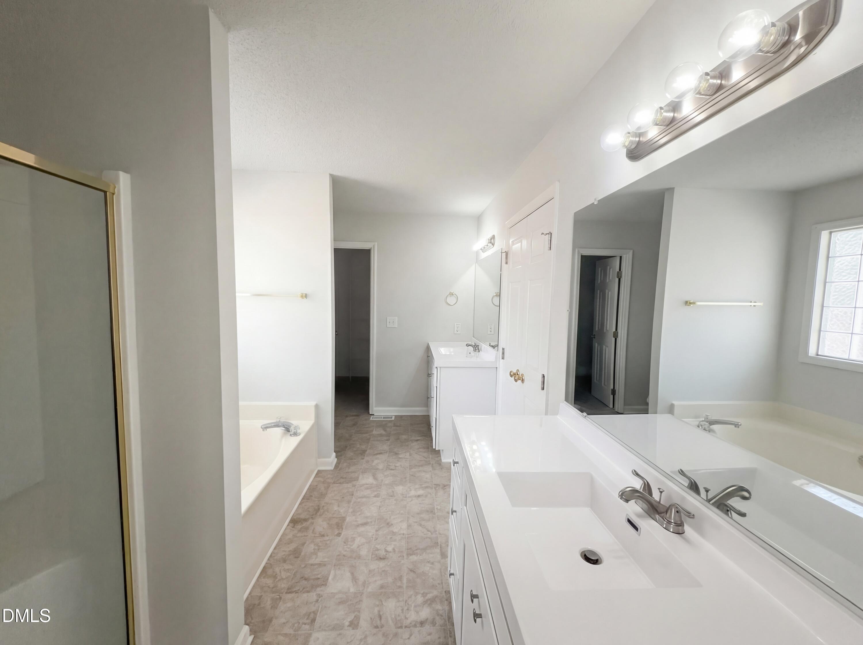299 Greenleaf Road Angier, NC 27501 - Photo 8 of 15 a bathroom with a tub sink and mirror