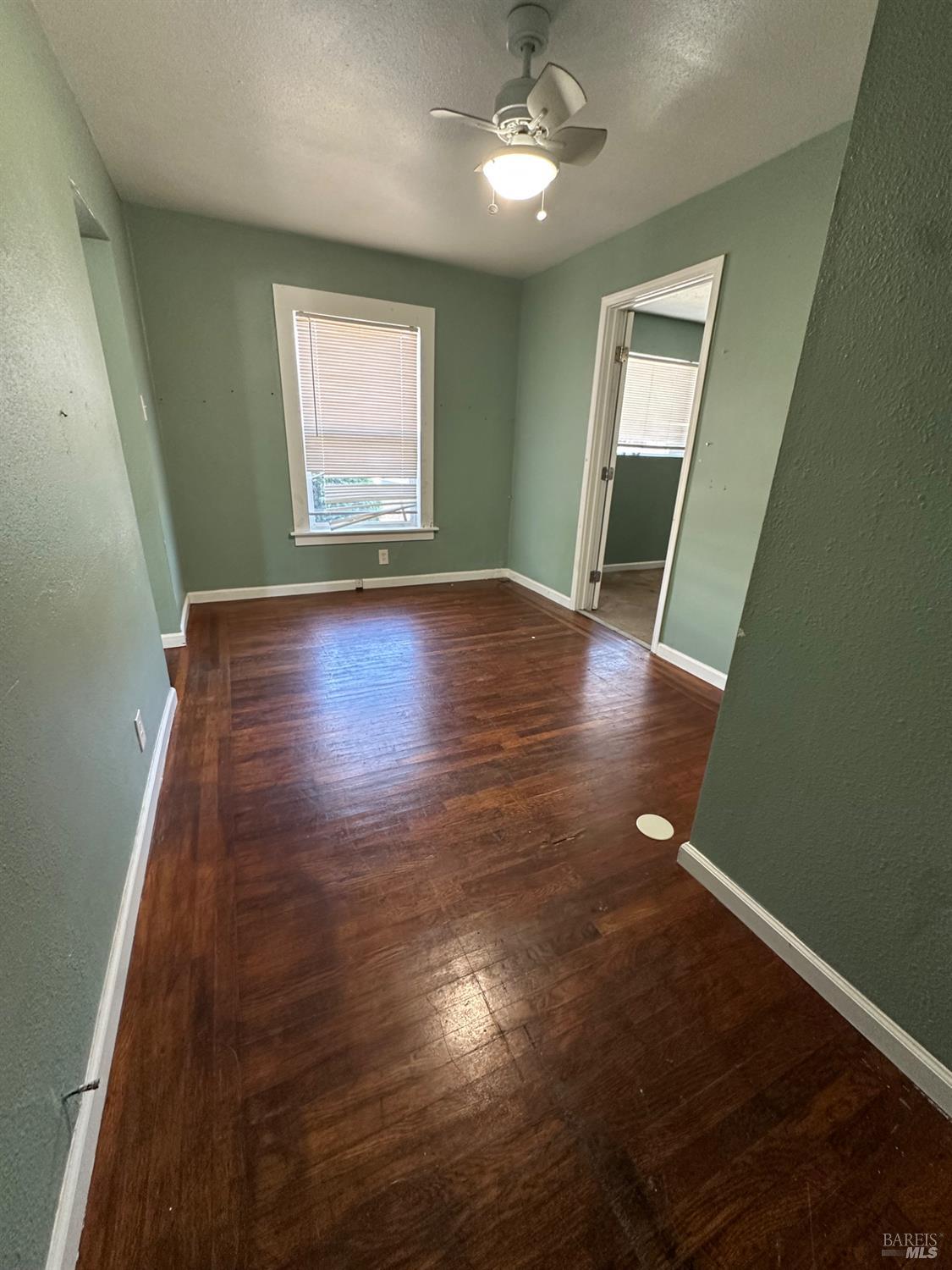 1815 Ohio Street Vallejo, CA 94590 - Photo 4 of 8 an empty room with wooden floor and windows