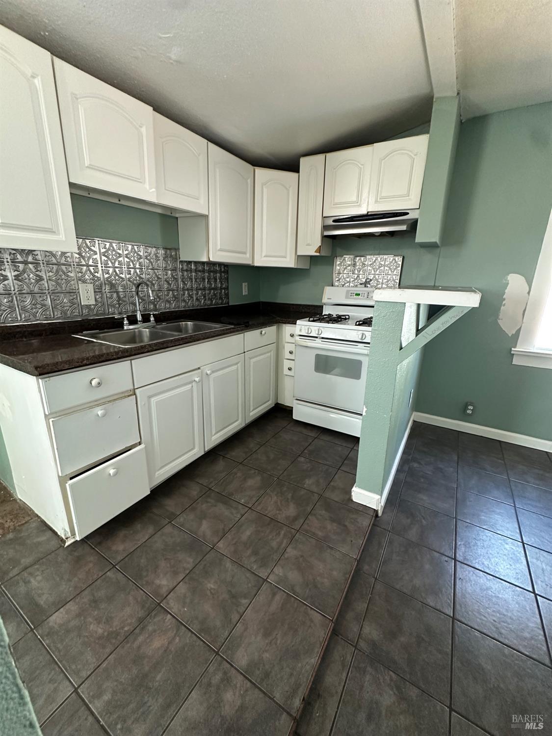1815 Ohio Street Vallejo, CA 94590 - Photo 6 of 8 a kitchen with stainless steel appliances granite countertop a sink stove and cabinets
