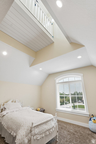 672 Perry Hollow Drive Mapleton, UT 84664 - Photo 54 of 106 Room featuring a vaulted ceiling with recessed lighting, an arched window, a carpeted floor, and a white interior balcony with a slatted railing