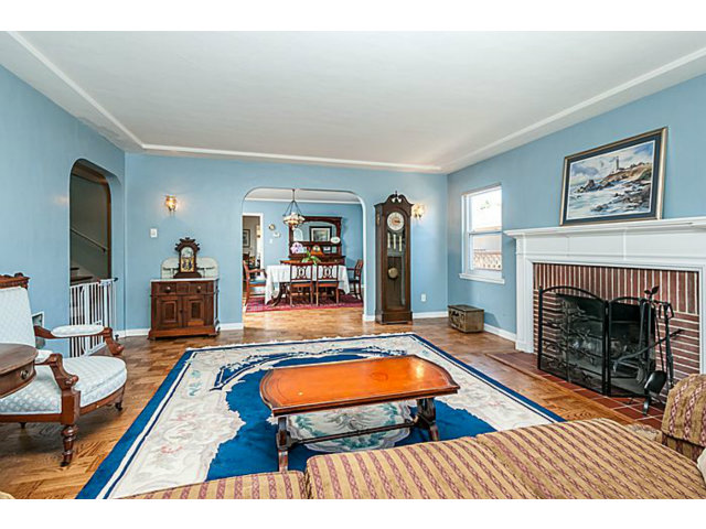 29 Dwight Road Burlingame, CA 94010 - Photo 3 of 20 a living room with furniture a fireplace and paintings on wall