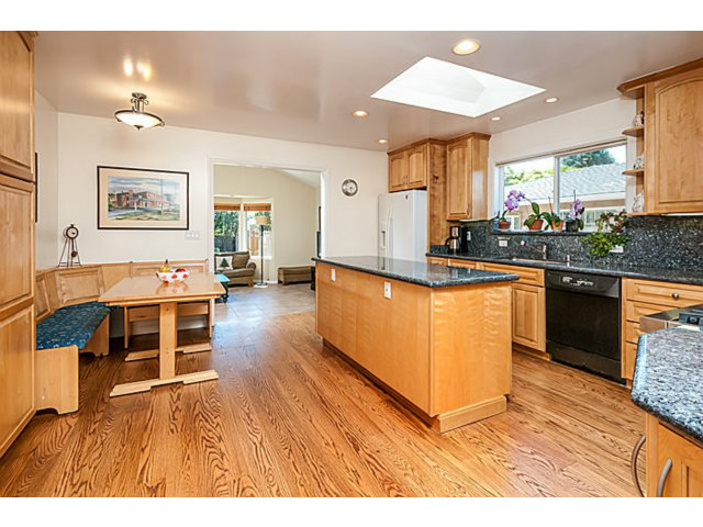 29 Dwight Road Burlingame, CA 94010 - Photo 6 of 20 a living room with stainless steel appliances kitchen island granite countertop furniture a lamp and a kitchen view