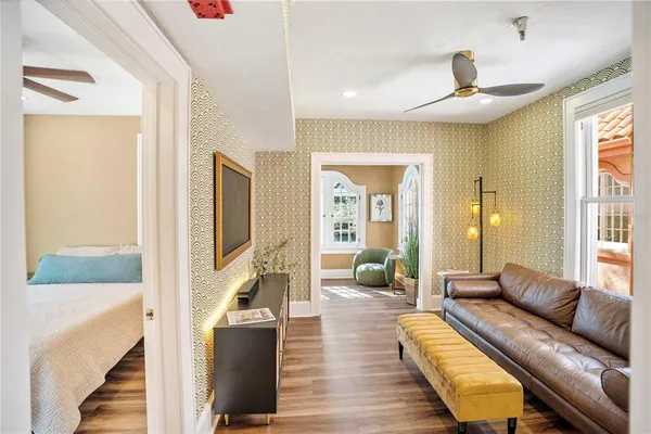 a living room with furniture and a wooden floor