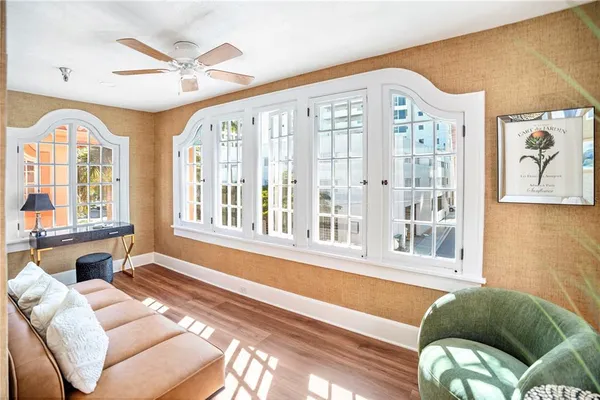 a table and chairs in a room next to a window