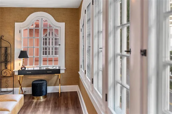 a living room with a large window and furniture