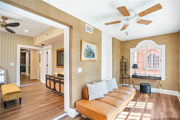 a living room with furniture and wooden floor