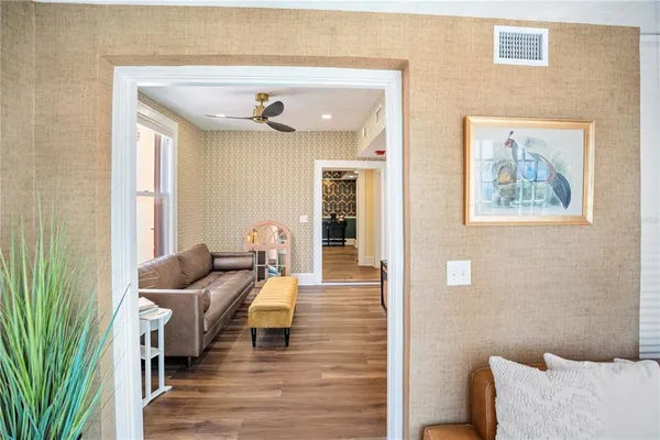 a living room with furniture and a wooden floor
