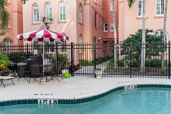 a swimming pool with outdoor seating and yard