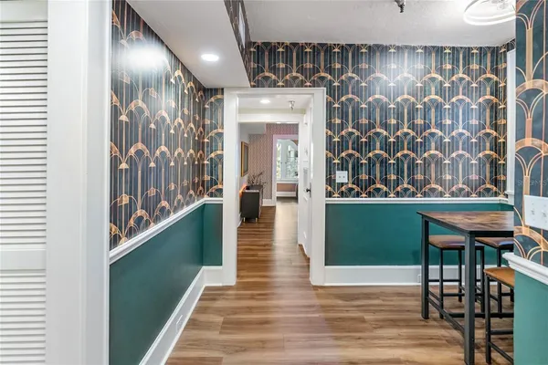 a view of a dining room with furniture and wooden floor