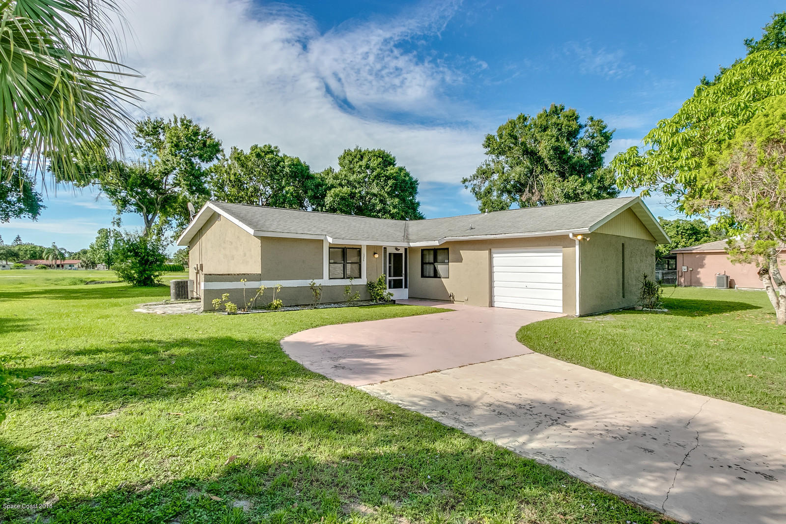 1586 Creel Road Northeast Palm Bay, FL 32905 - Photo 1 of 21 a front view of house with yard and trees
