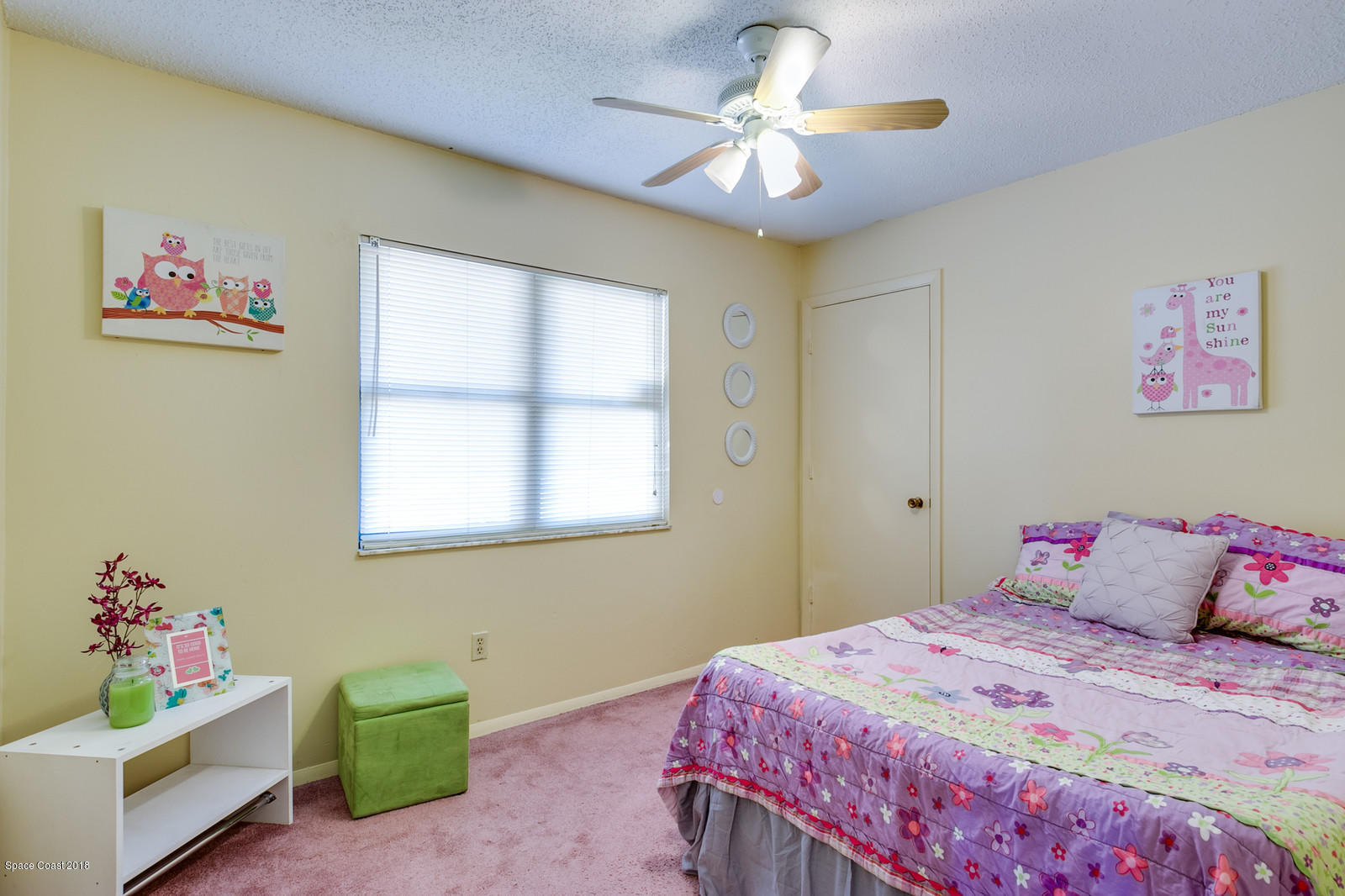 1586 Creel Road Northeast Palm Bay, FL 32905 - Photo 12 of 21 a bedroom with a bed and a chandelier