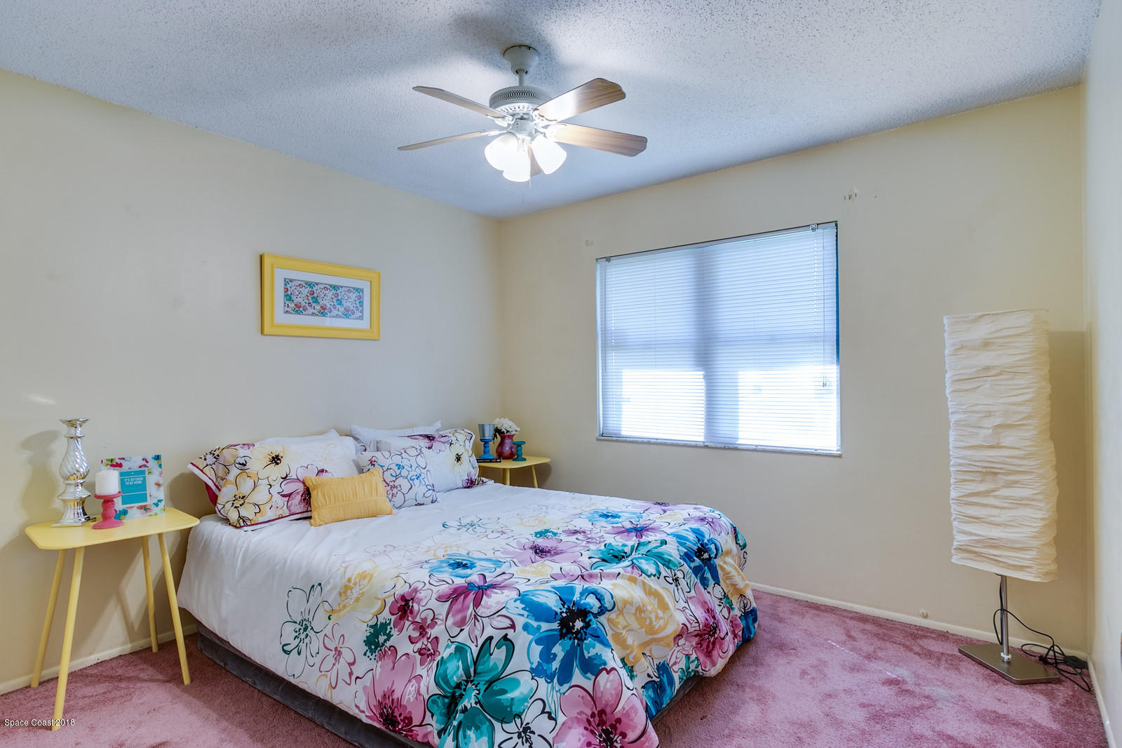 1586 Creel Road Northeast Palm Bay, FL 32905 - Photo 13 of 21 a bedroom with a bed and a chandelier