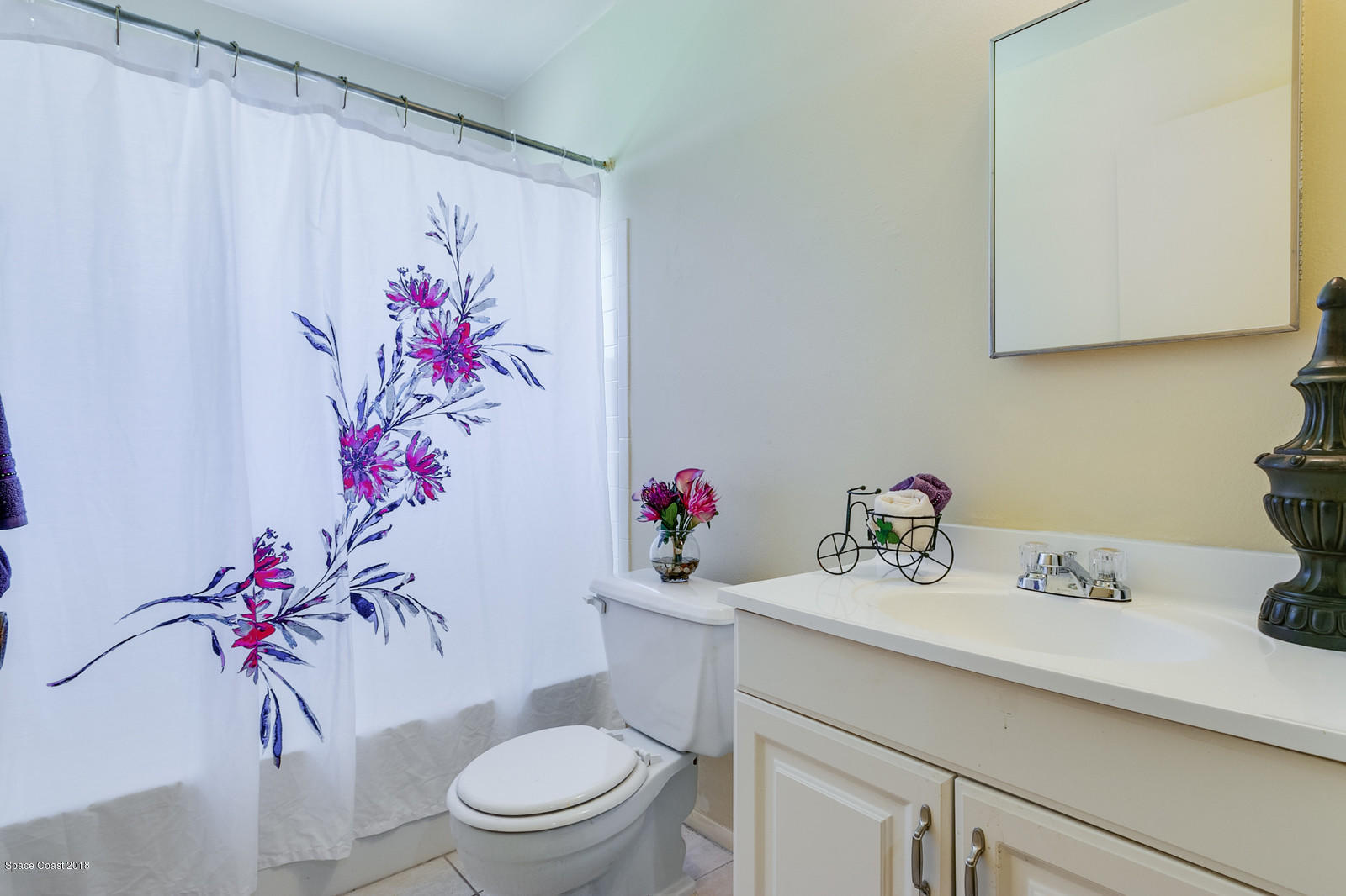 1586 Creel Road Northeast Palm Bay, FL 32905 - Photo 14 of 21 a bathroom with a sink mirror and toilet