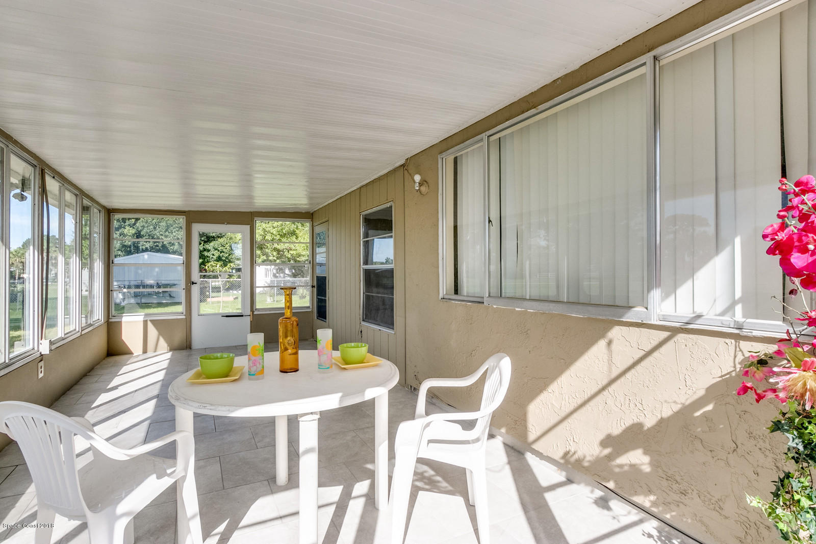 1586 Creel Road Northeast Palm Bay, FL 32905 - Photo 15 of 21 a view of a patio with a table and chairs and potted plants