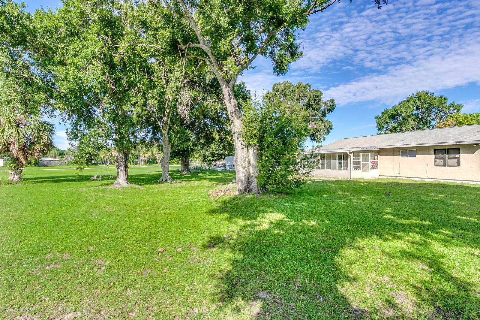 1586 Creel Road Northeast Palm Bay, FL 32905 - Photo 17 of 21 a view of a house with a big yard
