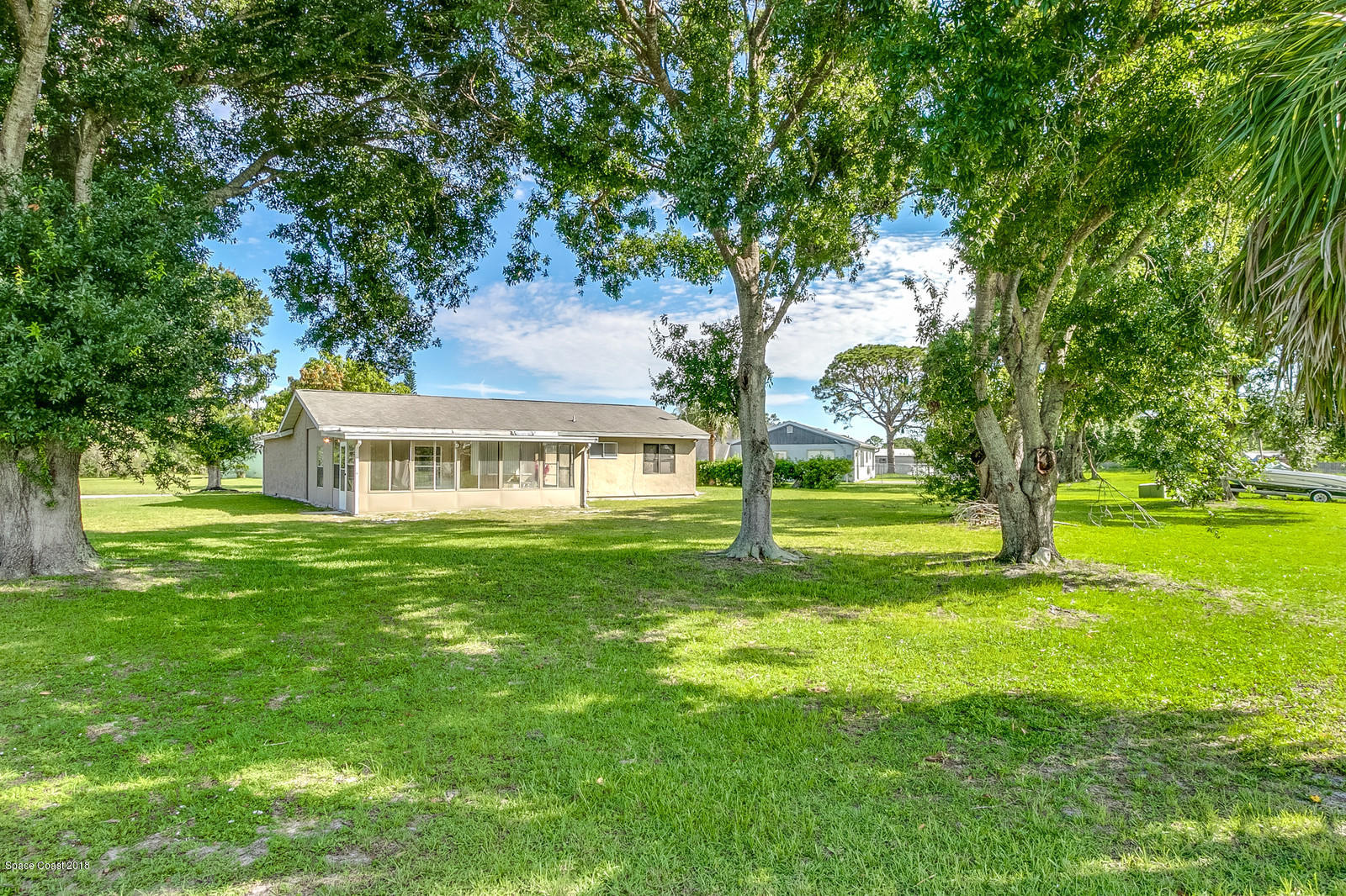 1586 Creel Road Northeast Palm Bay, FL 32905 - Photo 18 of 21 a view of a house with a big yard