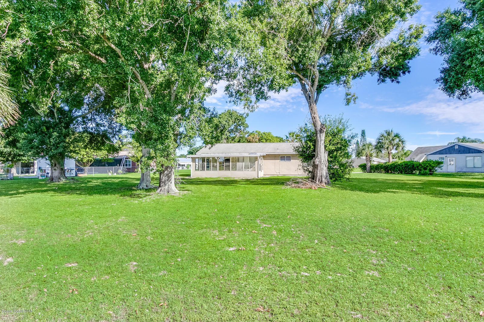 1586 Creel Road Northeast Palm Bay, FL 32905 - Photo 19 of 21 a view of a house with a yard