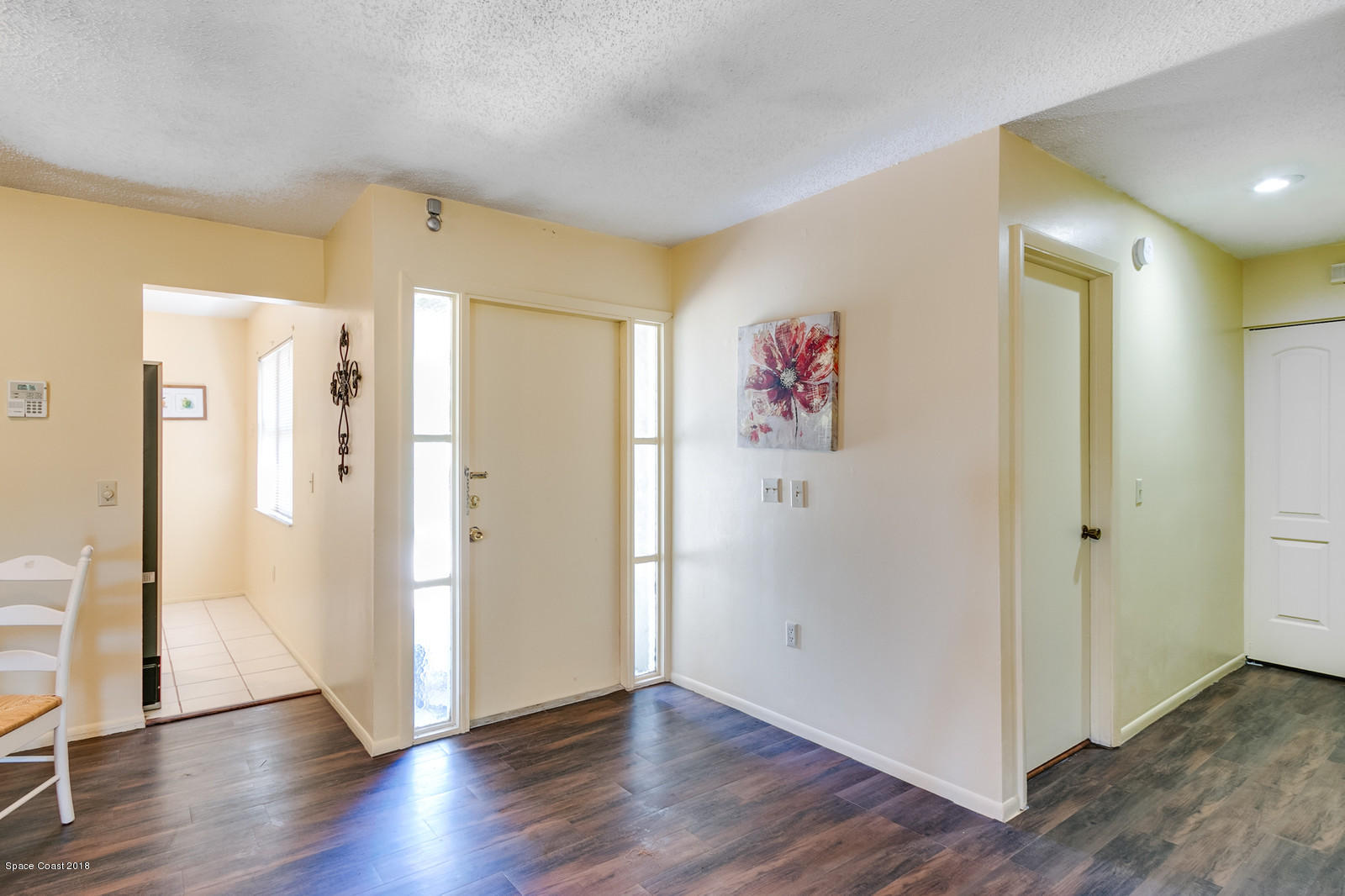 1586 Creel Road Northeast Palm Bay, FL 32905 - Photo 3 of 21 a view of a hallway with wooden floor and closet
