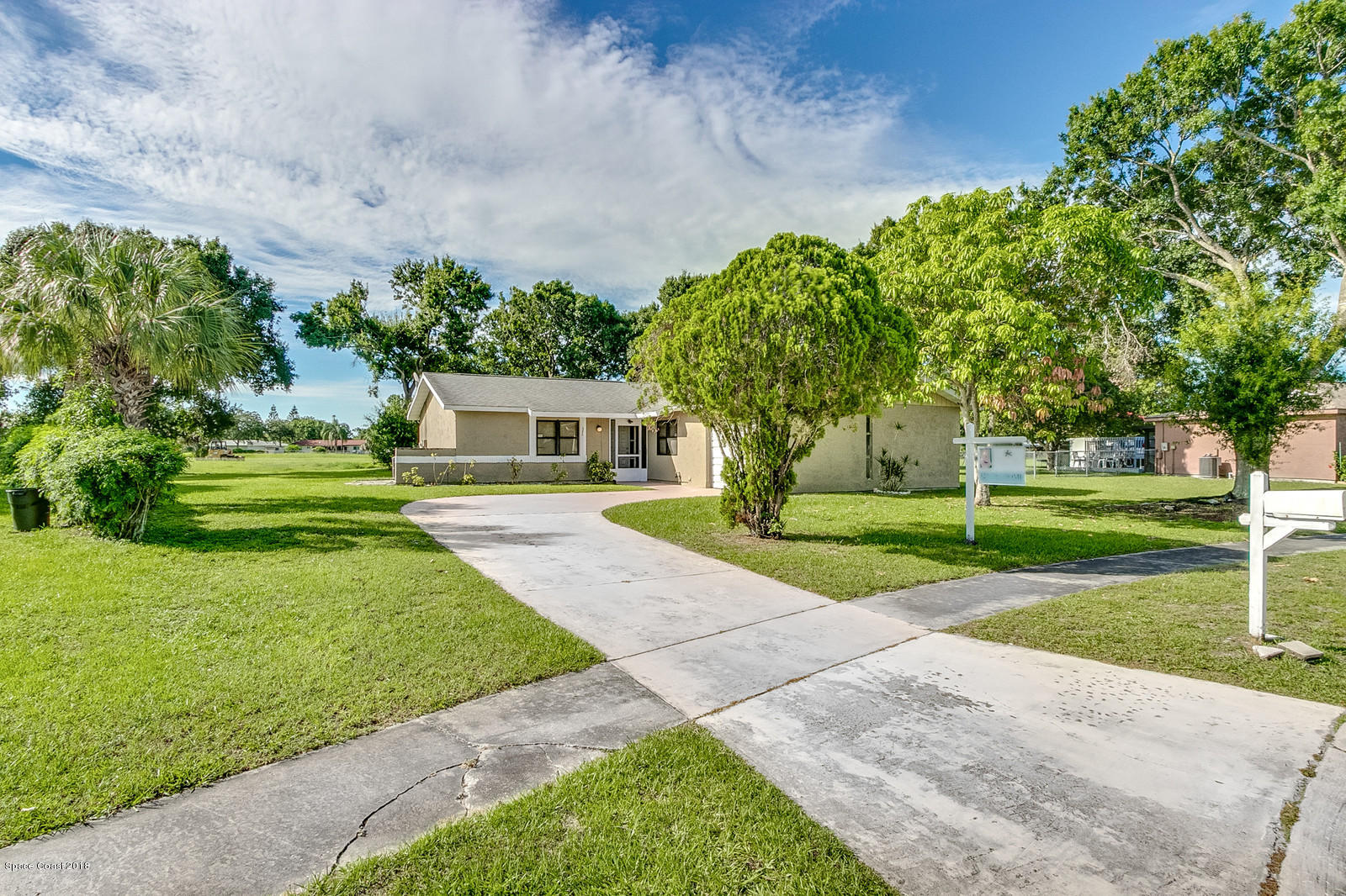 1586 Creel Road Northeast Palm Bay, FL 32905 - Photo 21 of 21 a front view of a house with a yard