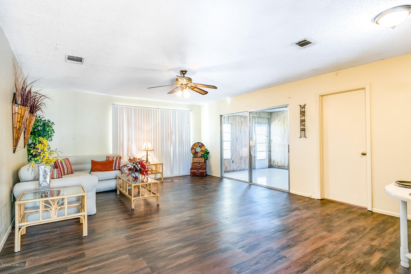 1586 Creel Road Northeast Palm Bay, FL 32905 - Photo 4 of 21 a living room with furniture and wooden floor