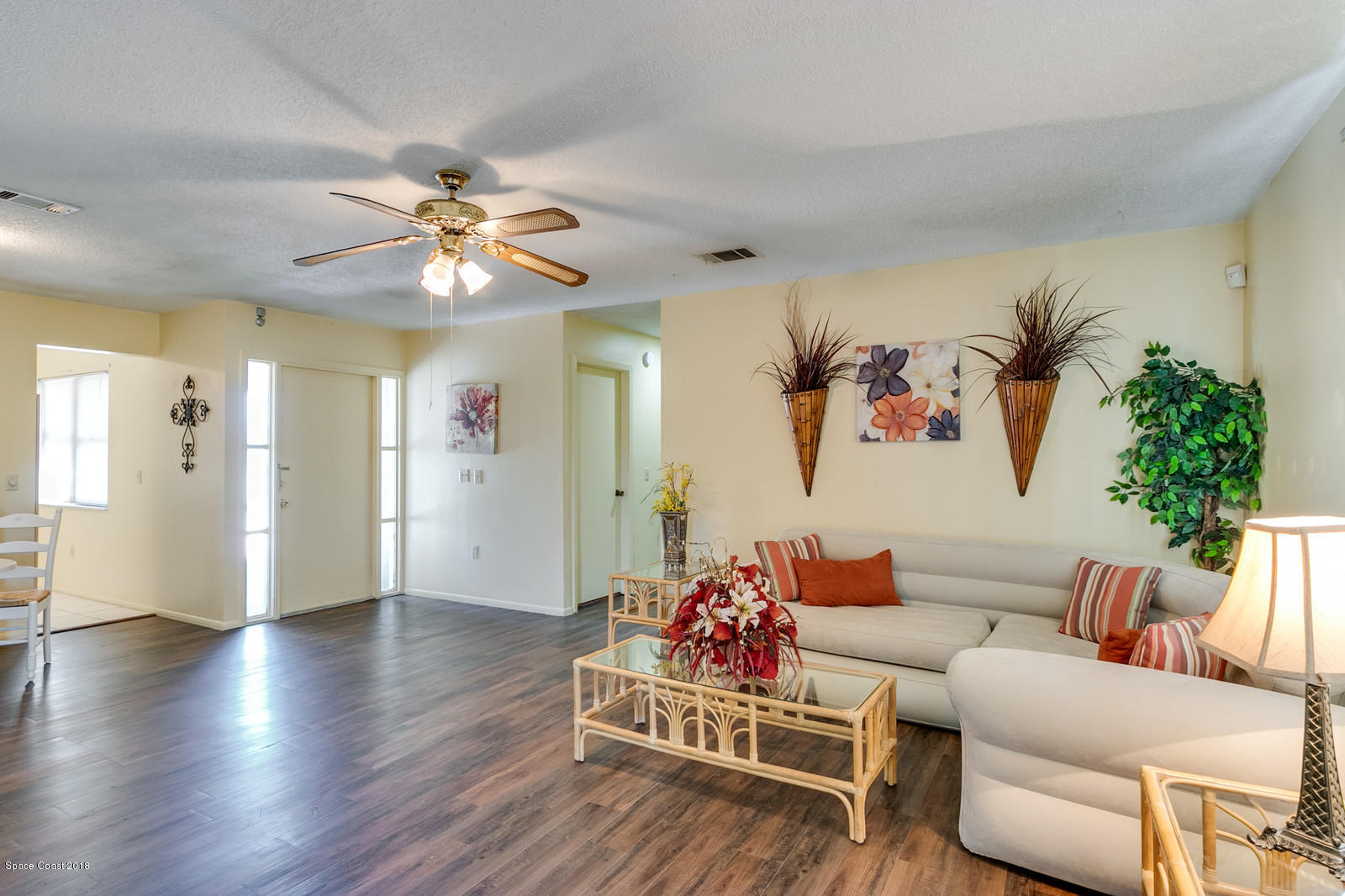 1586 Creel Road Northeast Palm Bay, FL 32905 - Photo 5 of 21 a living room with furniture flowerpot and a chandelier