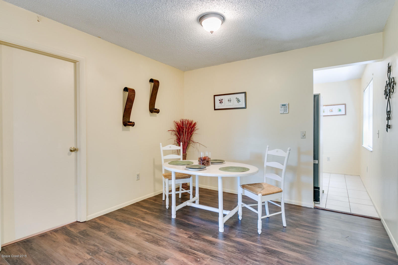 1586 Creel Road Northeast Palm Bay, FL 32905 - Photo 7 of 21 a view of a dining room with furniture and wooden floor