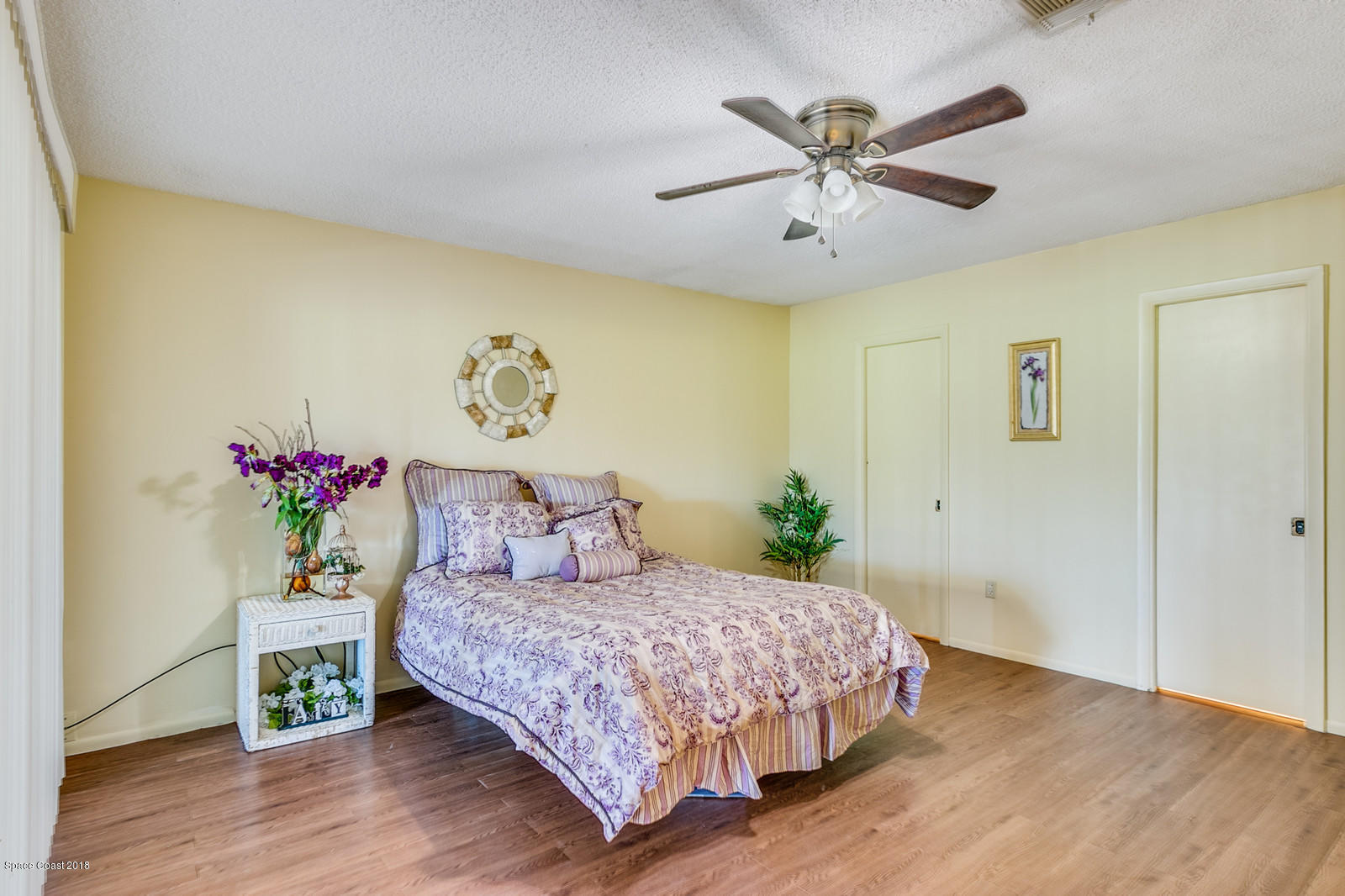 1586 Creel Road Northeast Palm Bay, FL 32905 - Photo 10 of 21 a bedroom with a bed chandelier and a potted plant