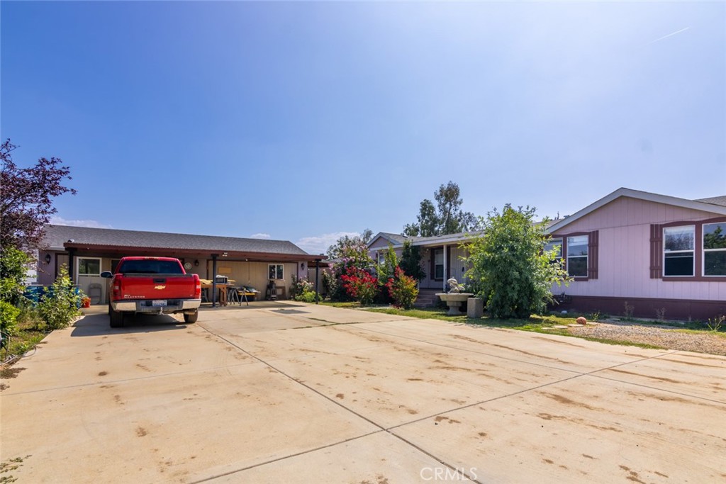 24074 Regency Road Homeland, CA 92548 - Photo 1 of 1 a car parked in front of a house