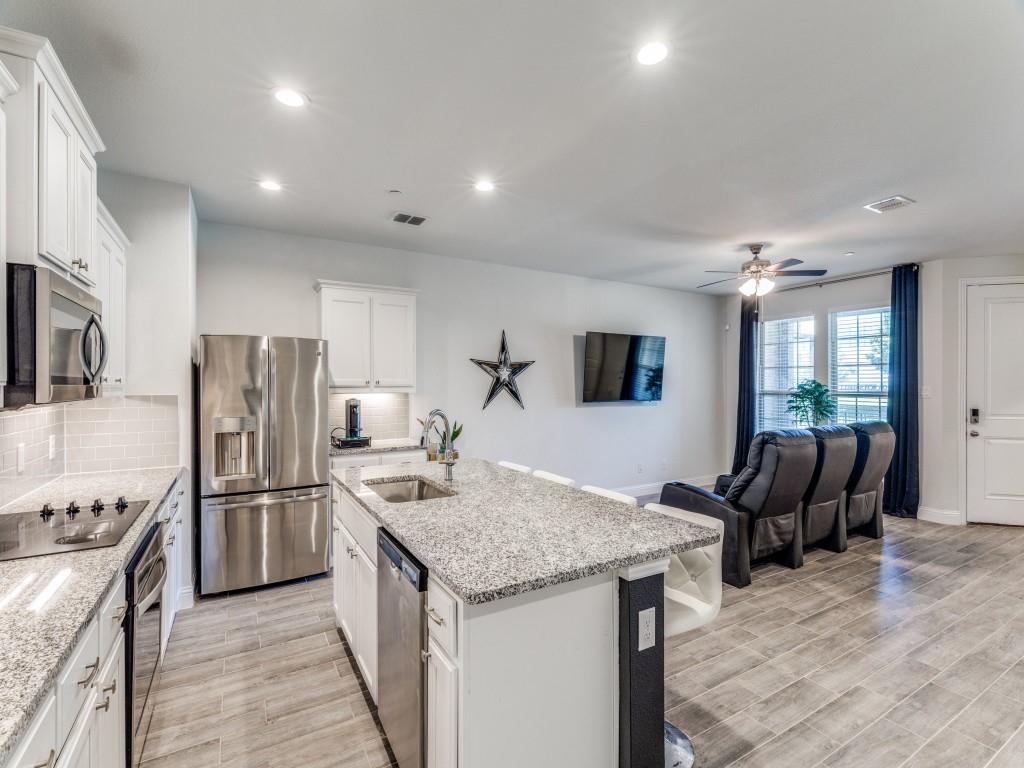 5944 Bursey Road Watauga, TX 76148 - Photo 7 of 25 a kitchen with stainless steel appliances granite countertop a refrigerator and a sink