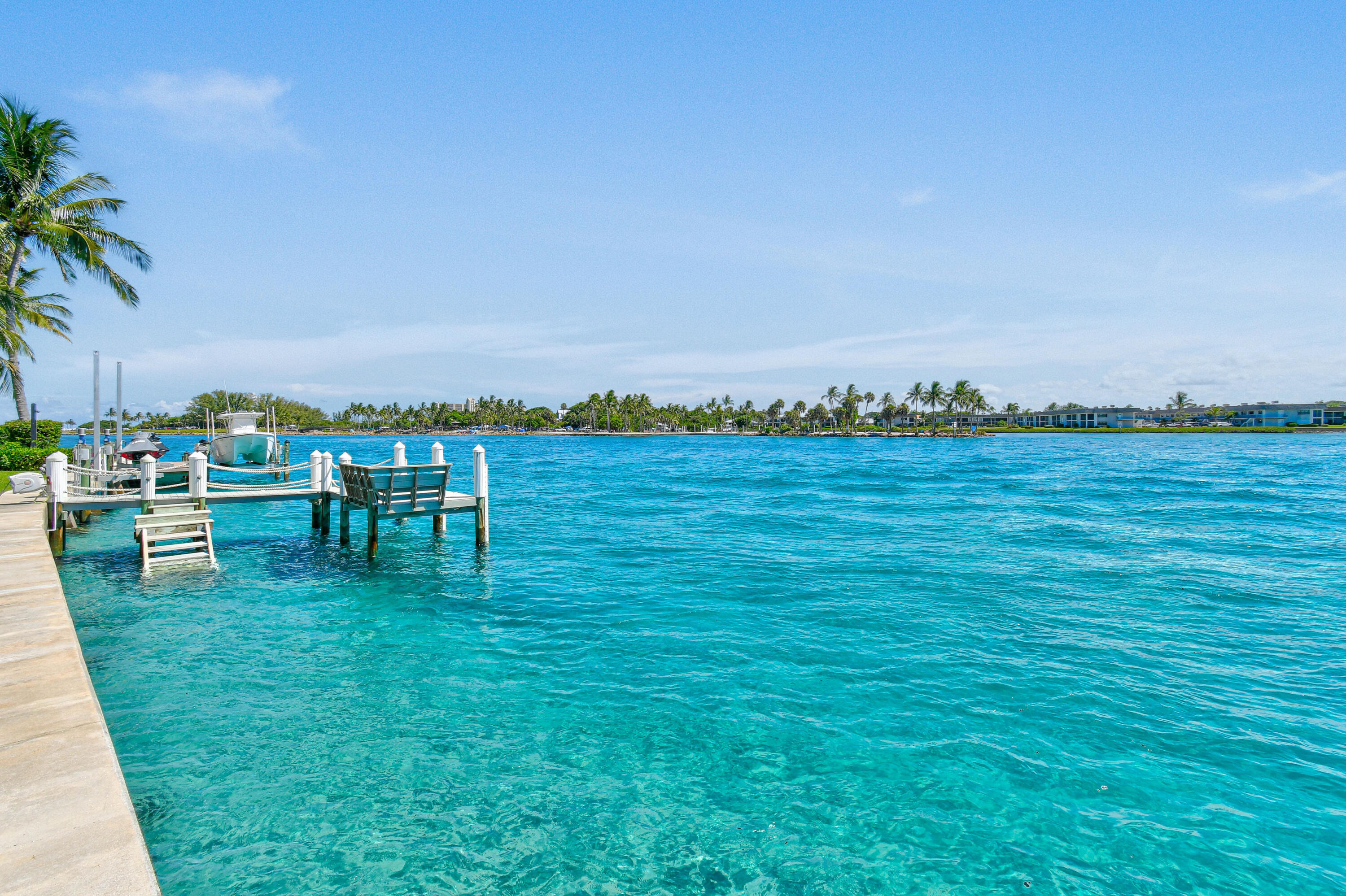 87 Lighthouse Drive Jupiter Inlet Colony, FL 33469 - Photo 16 of 33 a view of a lake with lawn chairs and a table