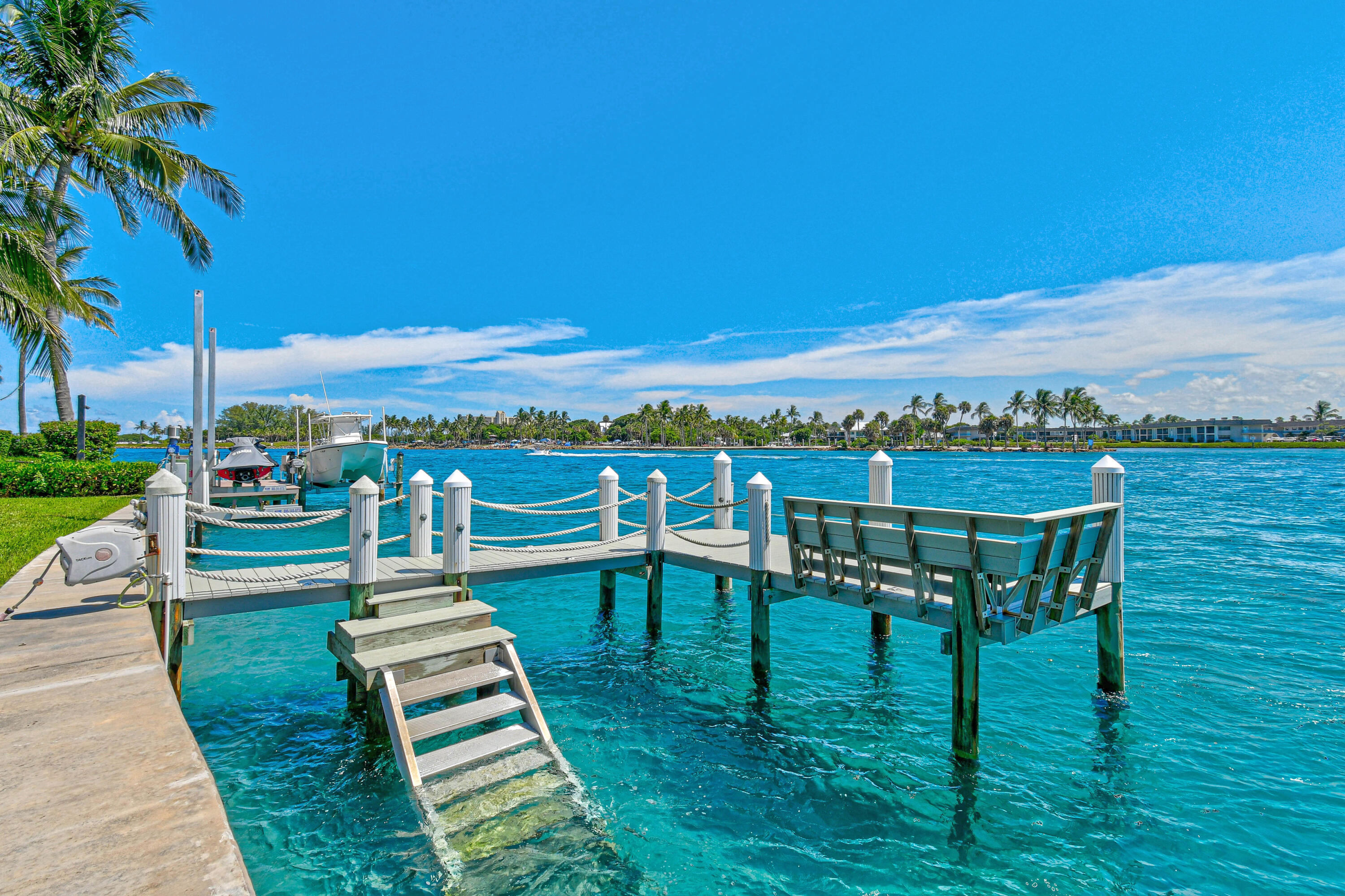 87 Lighthouse Drive Jupiter Inlet Colony, FL 33469 - Photo 17 of 33 a view of a chairs and table in patio with a lake view