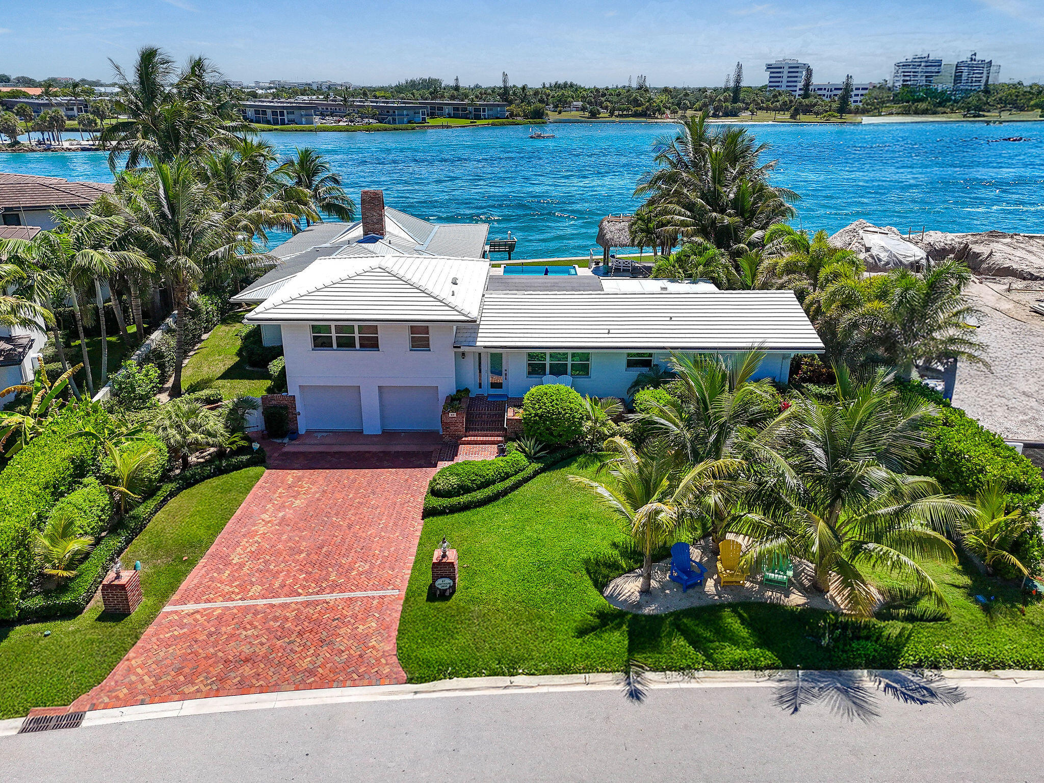 87 Lighthouse Drive Jupiter Inlet Colony, FL 33469 - Photo 2 of 33 an aerial view of a house with a yard and garden
