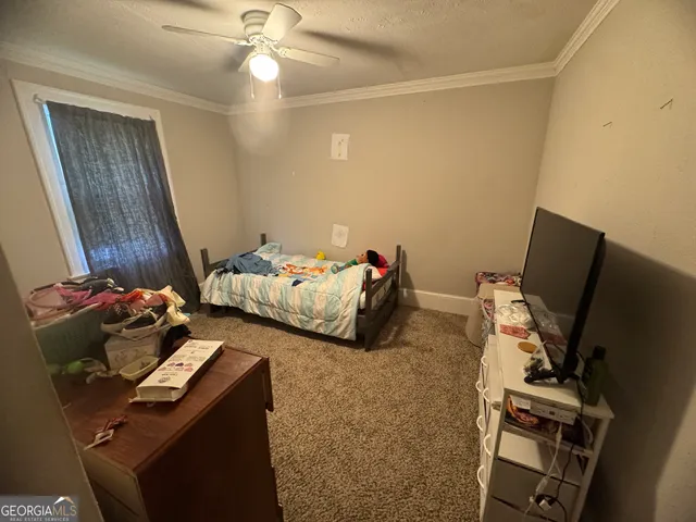 a bedroom with a bed and a mirror