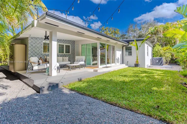 a view of a patio with table and chairs and potted plants