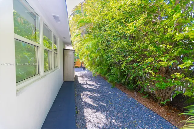 a view of a pathway of a house with a yard