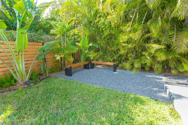 a backyard of a house with table and chairs