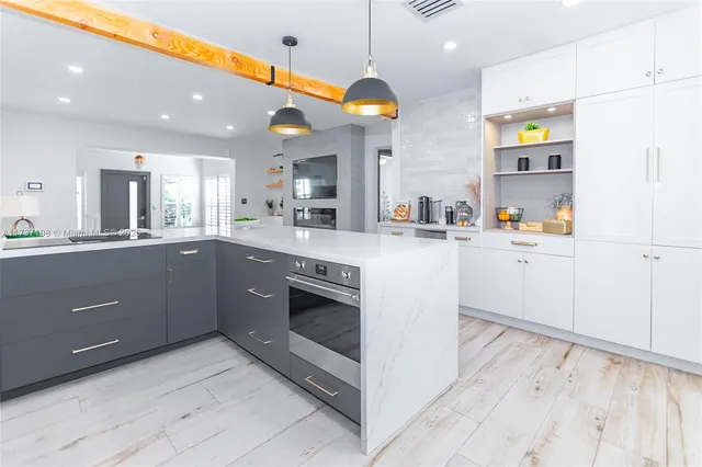 a kitchen with stainless steel appliances a sink stove and cabinets