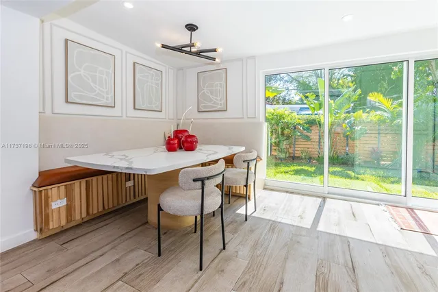 a view of a dining room with furniture window and wooden floor