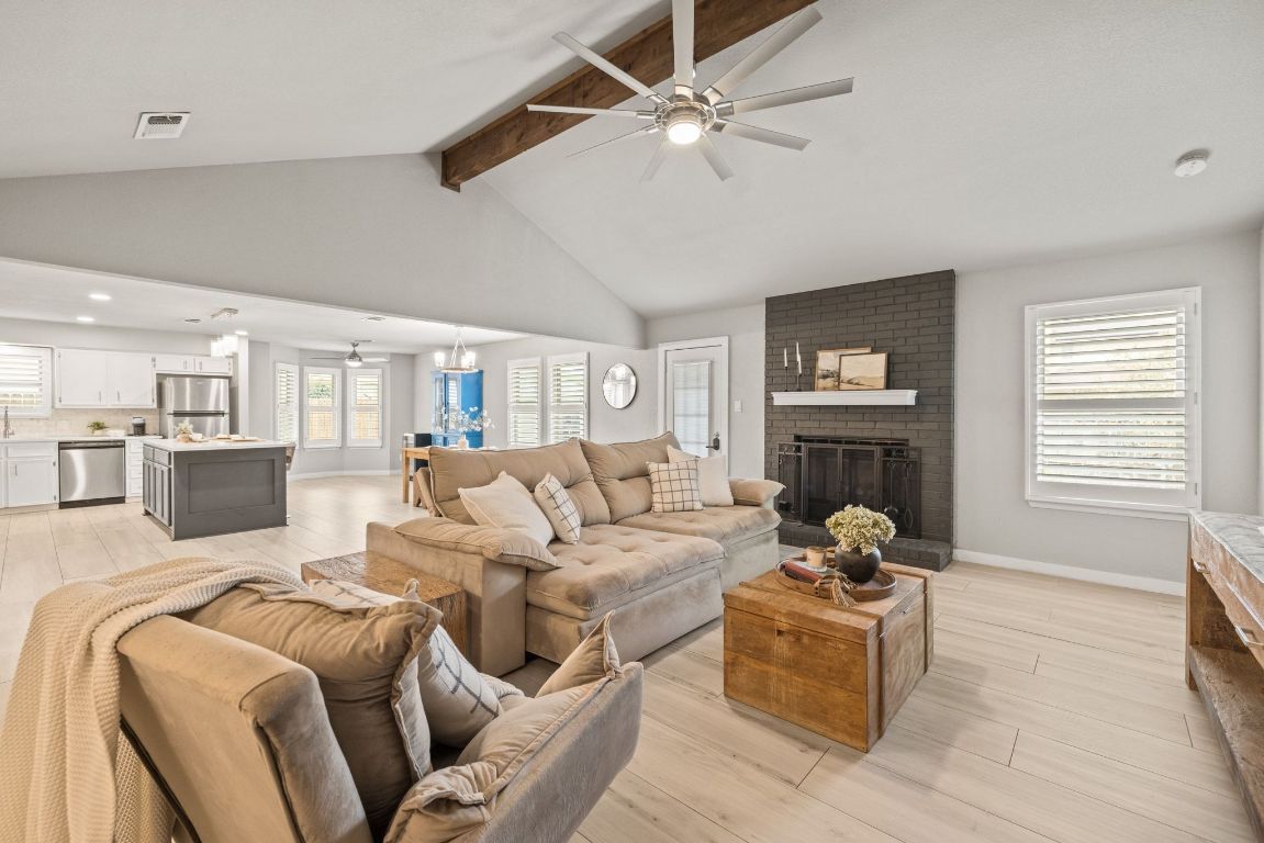 a living room with furniture fireplace and a window