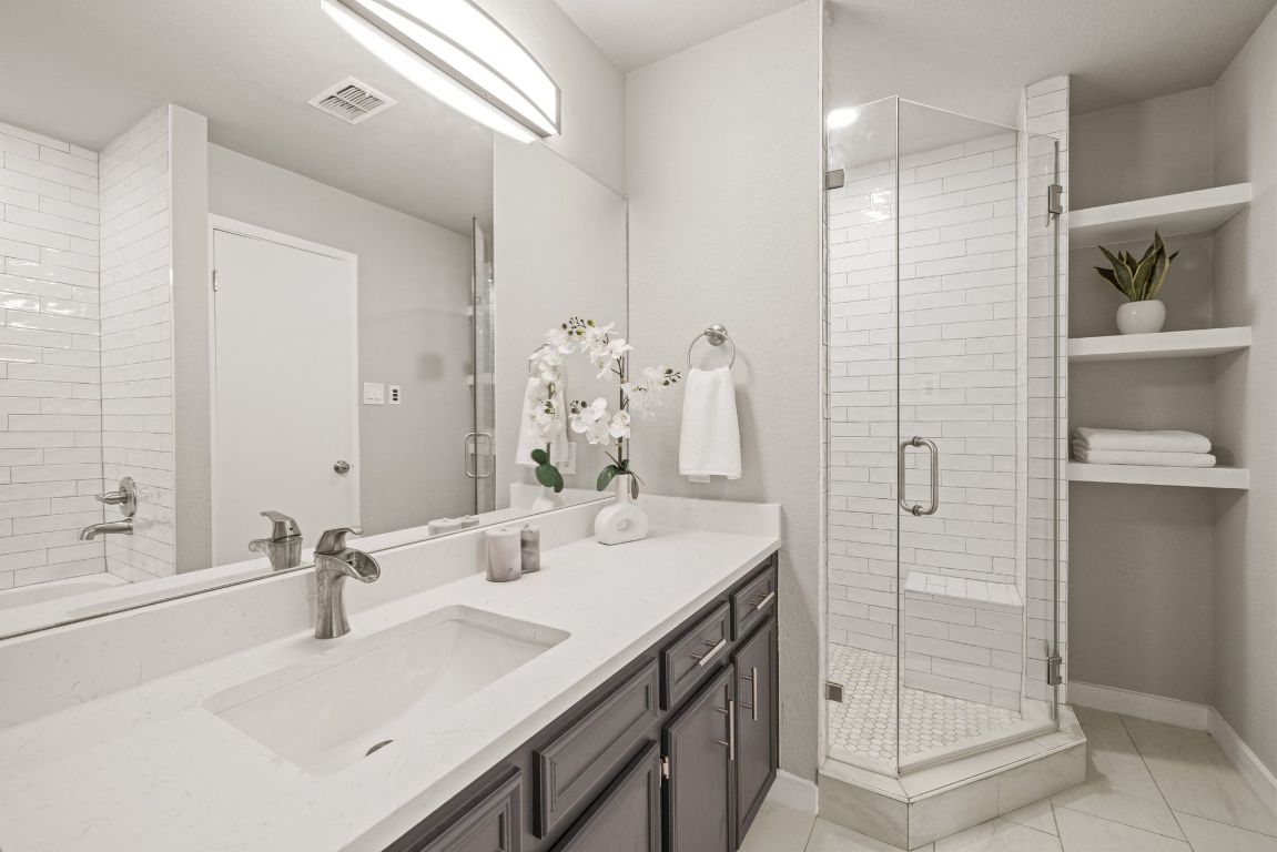 1805 Ryon Cove Round Rock, TX 78681 - Photo 14 of 23 a bathroom with a double vanity sink mirror and shower