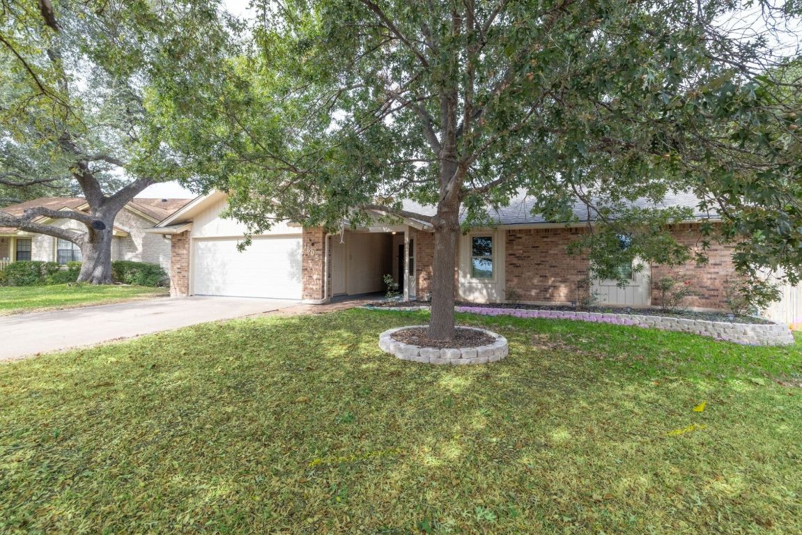 1805 Ryon Cove Round Rock, TX 78681 - Photo 23 of 23 a front view of a house with garden and trees
