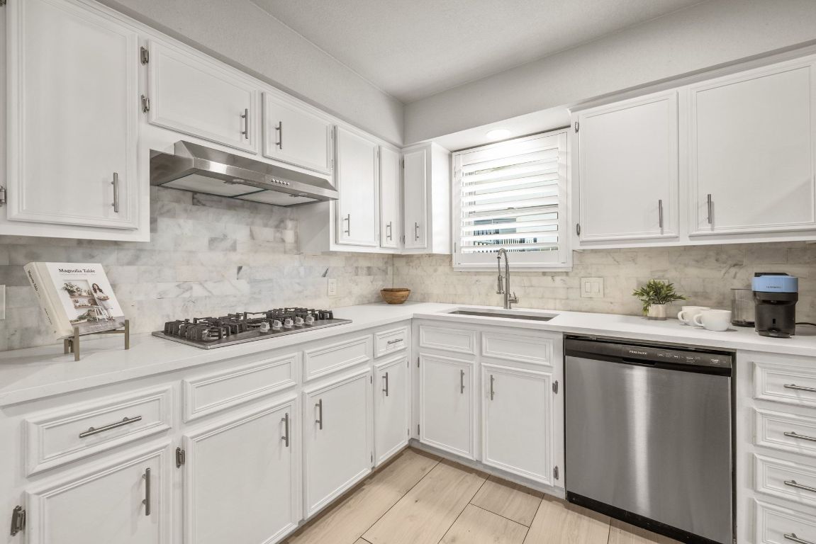 1805 Ryon Cove Round Rock, TX 78681 - Photo 4 of 23 a kitchen with cabinets appliances a sink and a window