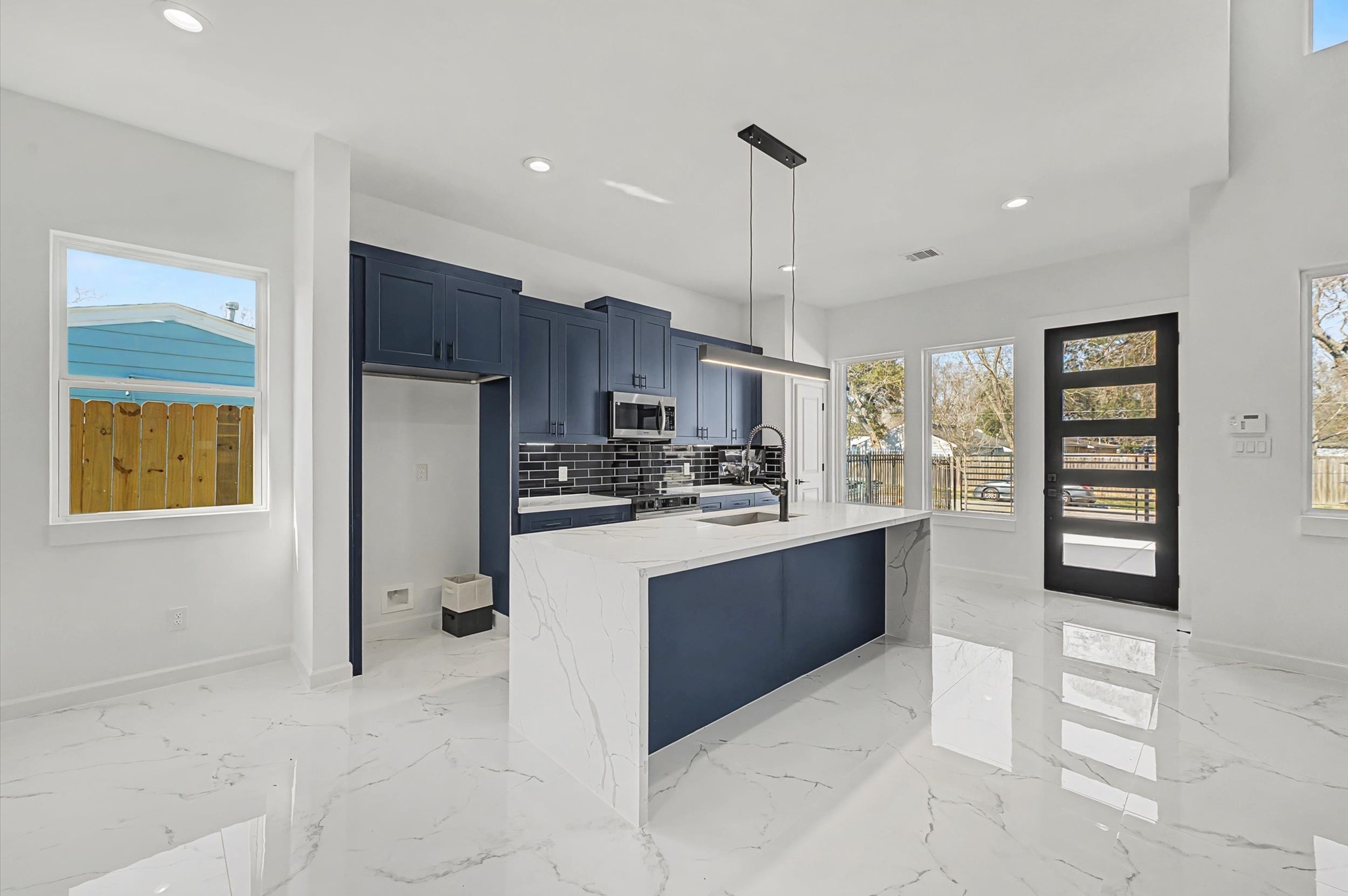 a kitchen with stainless steel appliances granite countertop a refrigerator and a sink